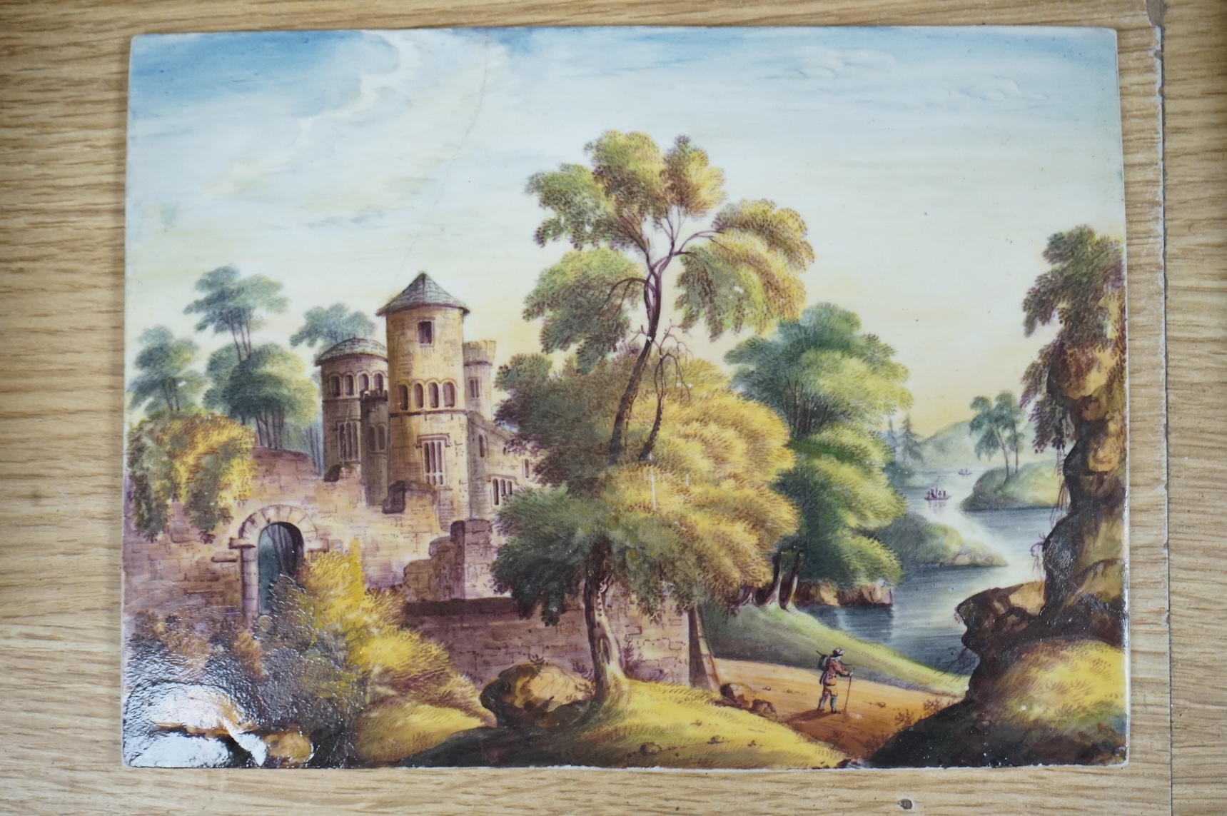Four ceramic painted plaques depicting landscapes to include ‘Upper Lake Killard’, three framed, largest 36cm wide